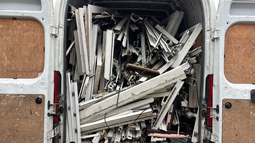 Bulk uPVC frames loaded for collection — volume drives better per-tonne rates