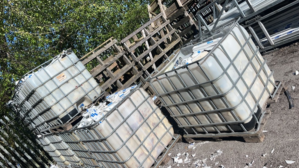 IBC storage tubs full of uPVC offcuts at a fabricator's site